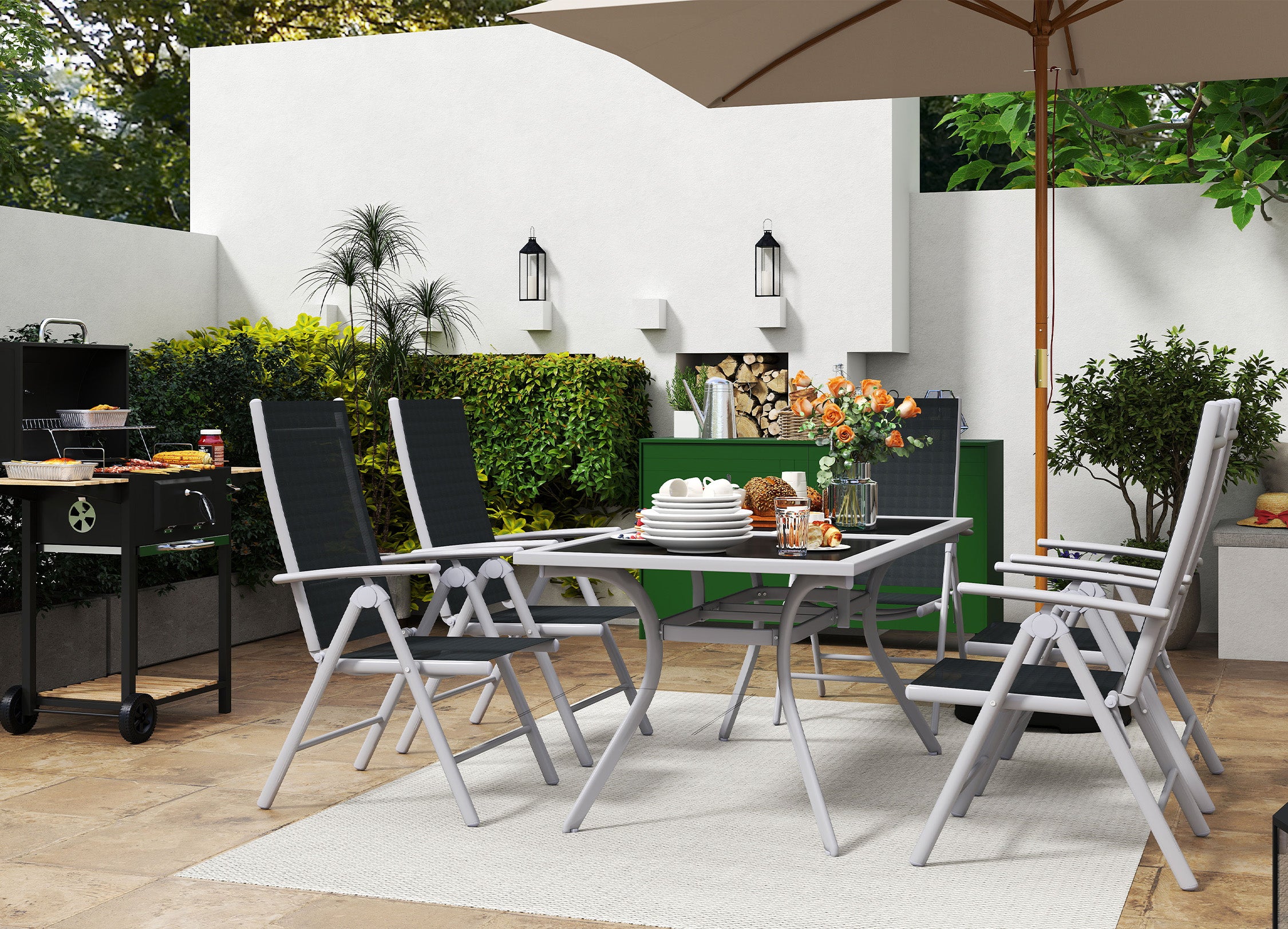 Outdoor patio set with table, chairs, and umbrella in a garden setting.