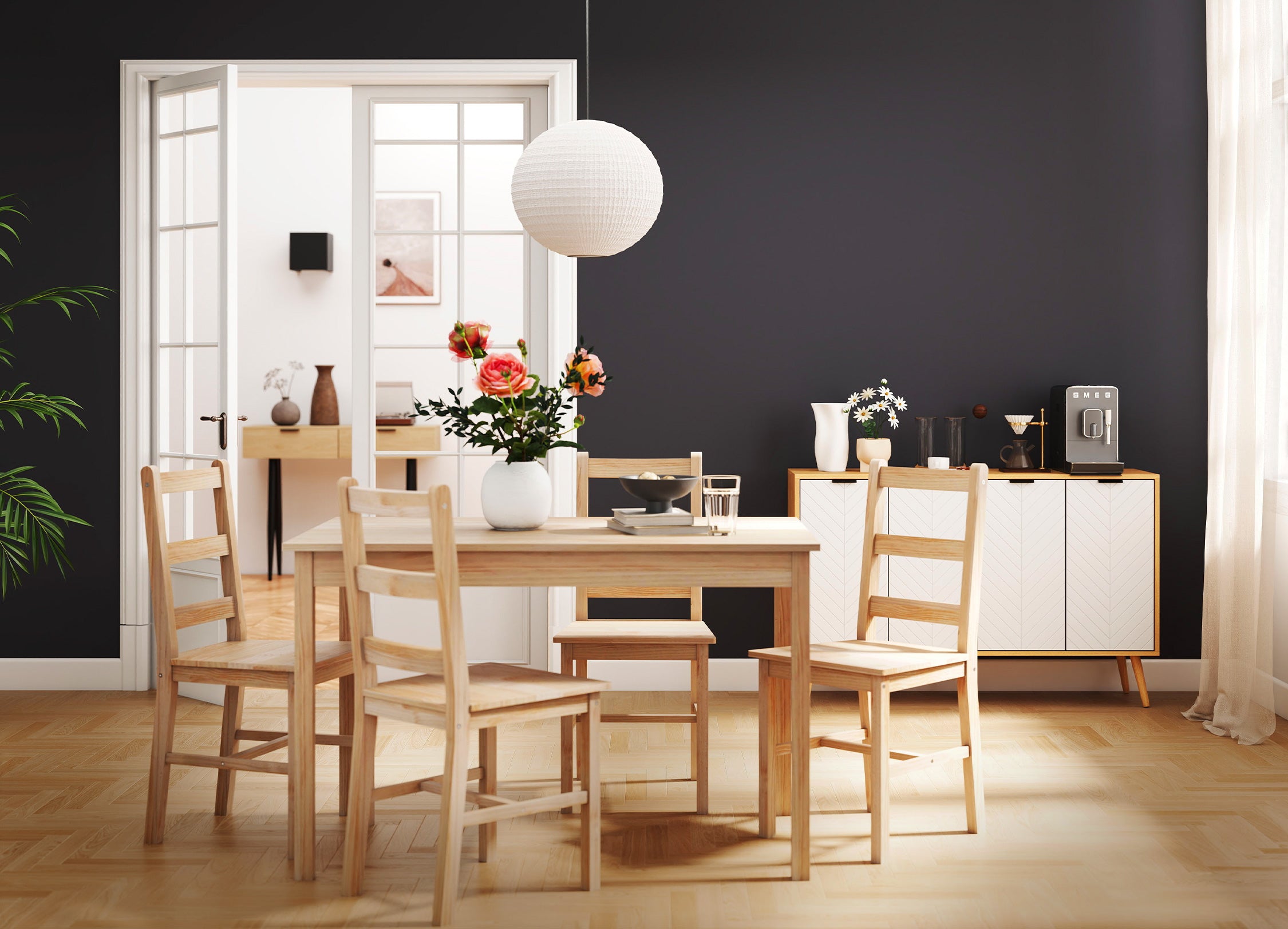 Dining room with wooden table and chairs against a black wall.