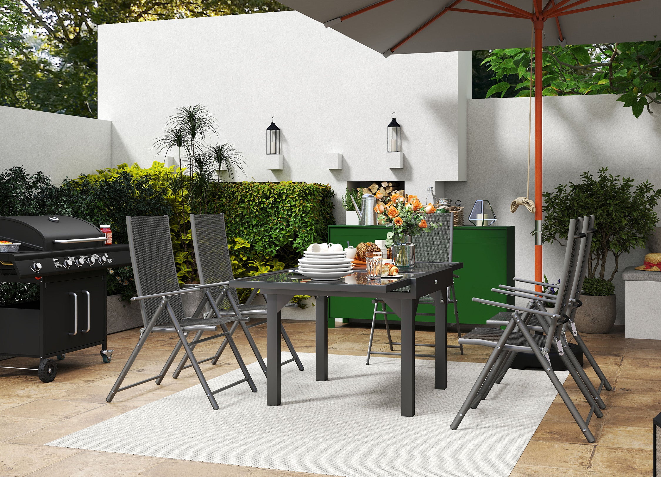 Outdoor patio setting with dining table, chairs, and grill under an umbrella.