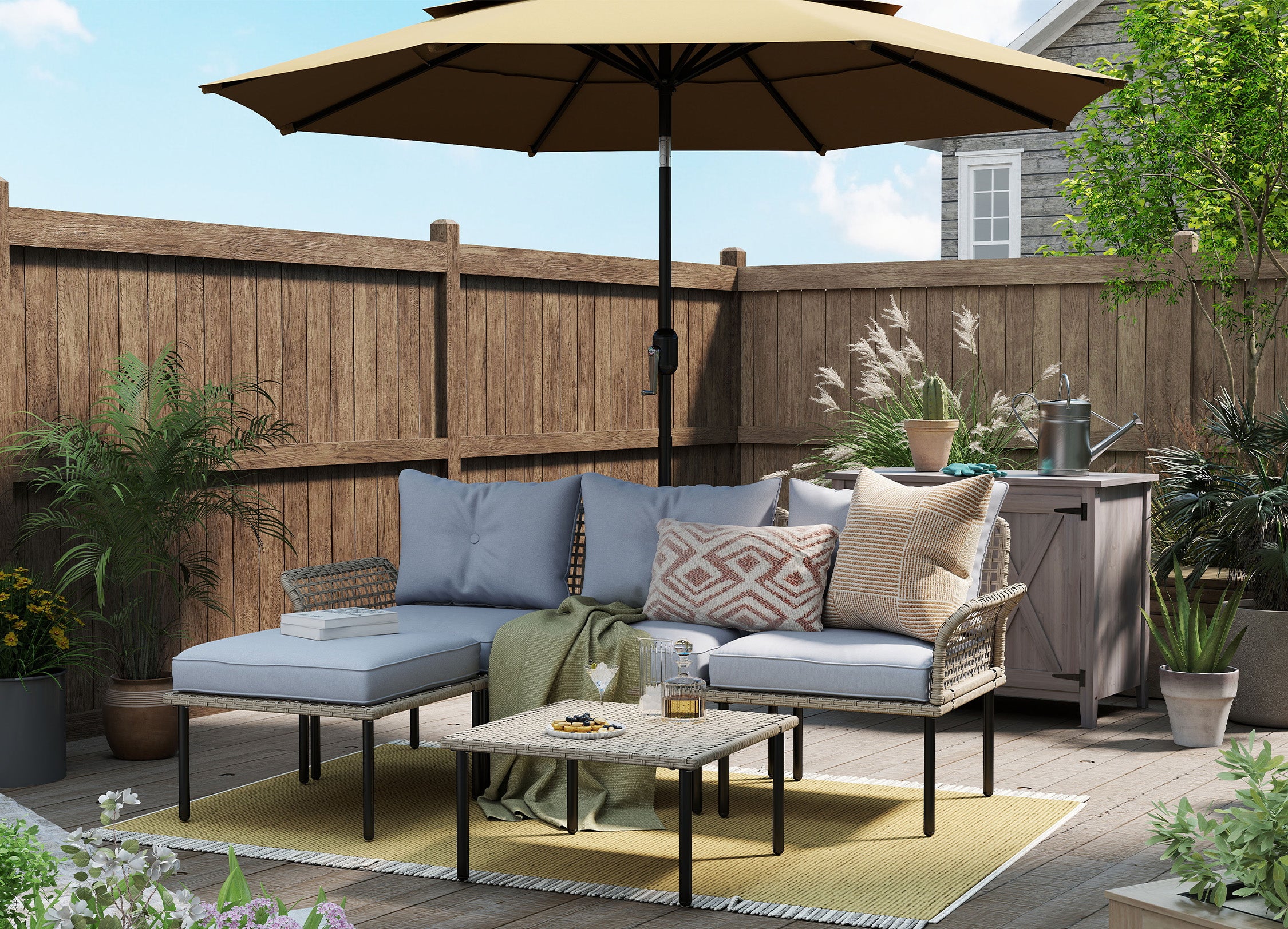 Outdoor patio with furniture, umbrella, and plants on a sunny day.